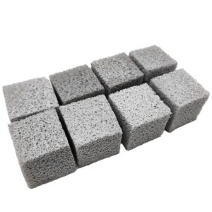 Nine gray, porous concrete cubes arranged in a 3-by-3 grid.