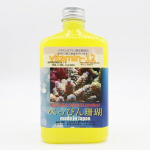 Yellow bottle labeled Vitamin-12 for aquariums, with a coral reef photo on the front label (made in Japan).