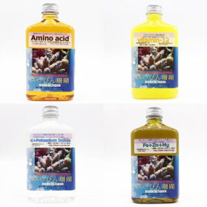 Four bottles of aquarium supplements arranged in a 2x2 grid; labels read Amino acid, Vitamin-12, K+ Potassium Iodide, and Fe+Zn+Mg, all made in Japan with coral images on the labels.
