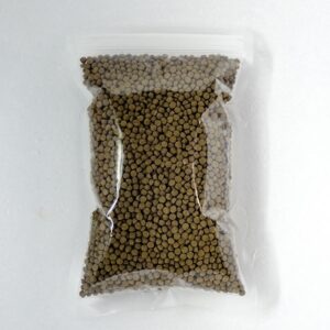 Clear plastic bag filled with small brown dry pellets, likely pet kibble or animal feed, photographed against a light background.